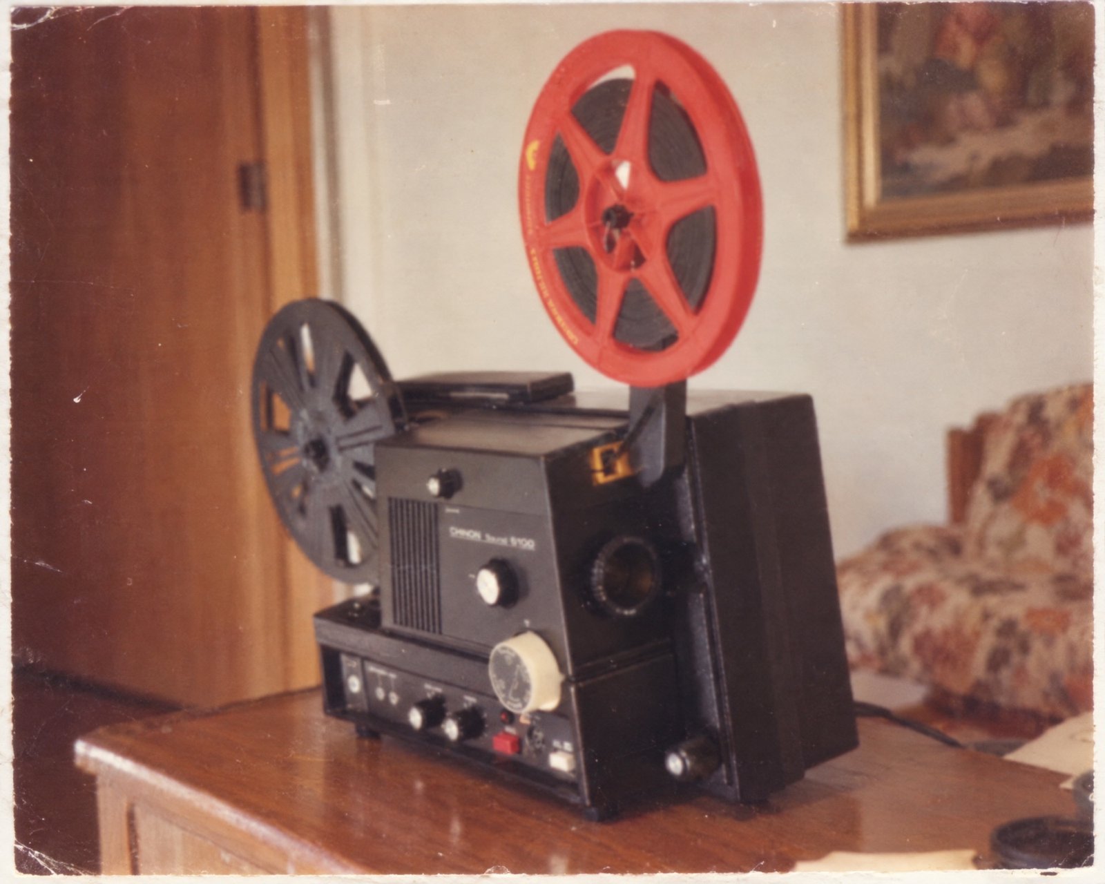 The family's Super 8 projector, a red reel on top